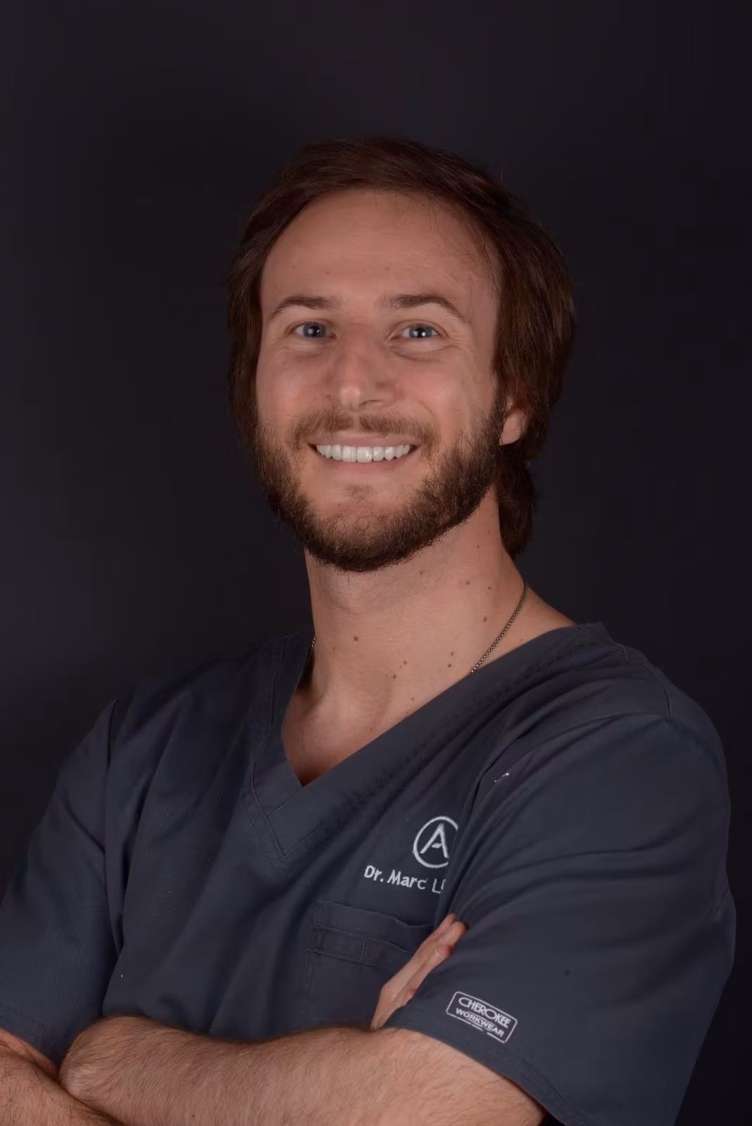 Dr Marc Llaquet smiling in a professional portrait.